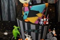 19 a bright and fun Nightmare Before Christmas weddign cake with all the themed decor on it and around it is fabulous