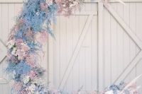 20 an iridescent half moon wedding backdrop covered with white, pink and blush blooms and pampas grass all over