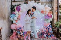 21 a jaw-dropping wedding backdrop covered with pink iridescent sequins, with spray painted fronds, blooms and balloons is breathtaking