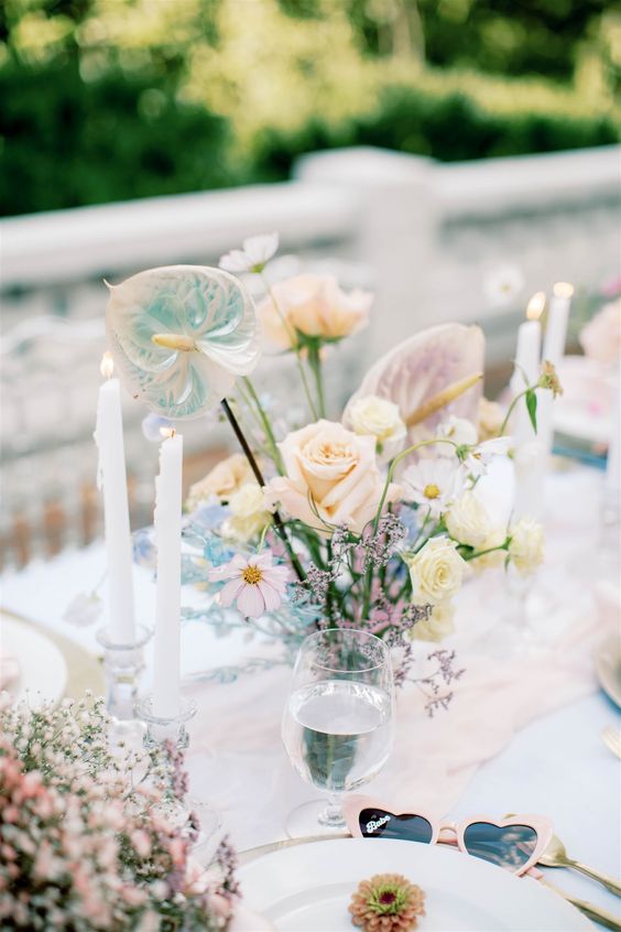 a lovely iridescent wedding tablescape with a blush table runner, an iridescent floral arrangement is chic