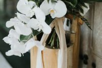 25 an elegant white wedding bouquet of cascading orchids, peonies, berries and foliage is a gorgeou sidea for a minimalist bride