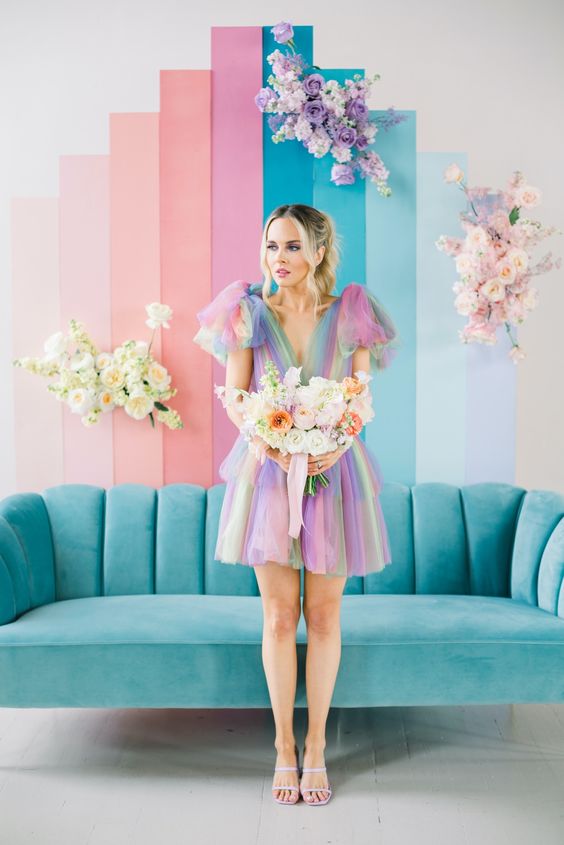 an iridescent wedding backdrop, a turquoise sofa, a colorful wedding dress and a pastel wedding bouquet for a lovely iridescent wedding