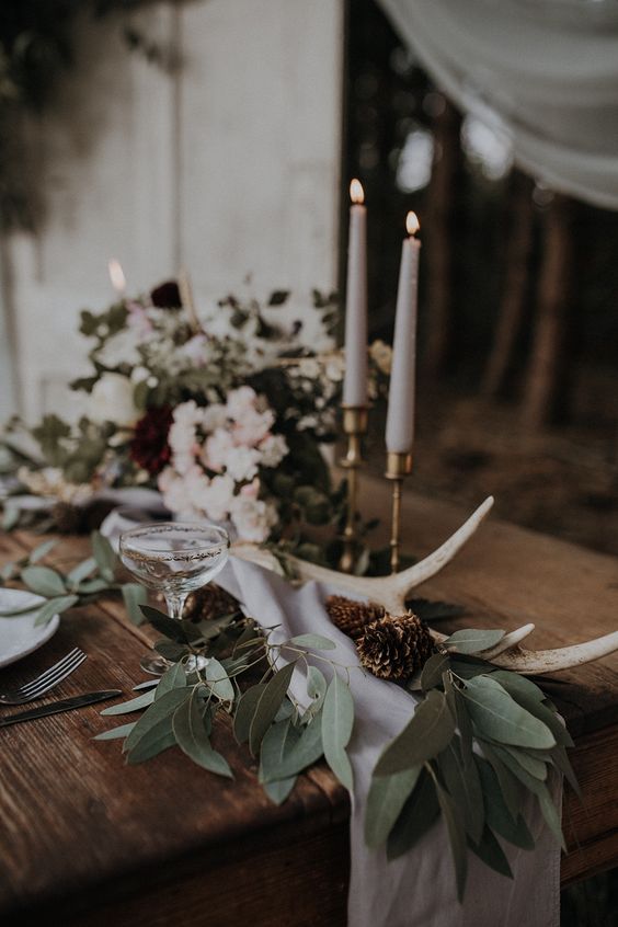 a wedding centerpiece with antlers is perfect for rustic look