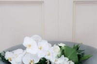 29 a textural and chic minimalist wedding bouquet of white orchids, hydrangeas and various foliage is a lovely idea to go for