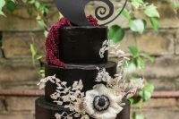 30 an elegant and chic Tim Burton wedding cake in black, with dried blooms and leaves and a lovely themed cake topper is amazing