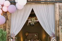 30 beautiful iridescent wedding barn decor with pleated curtains, blush and lilac blooms, disco balls and lilac candles, matching balloons