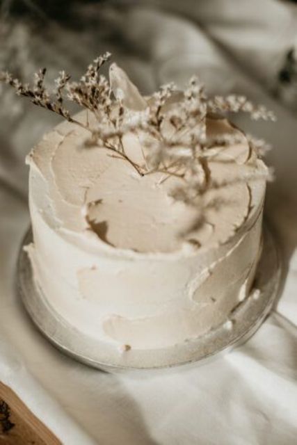 a neutral textural winter wedding cake topped with dried blooms is a stylsih idea not only for a winter wedding