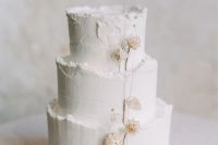 36 a textural white winter wedding cake with a raw edge and dried blooms is a lovely and cool idea that you may rock
