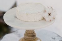 37 an alternative to a usual wedding cake – a cheese wheel with a cotton bud is a lovely idea for a winter wedding
