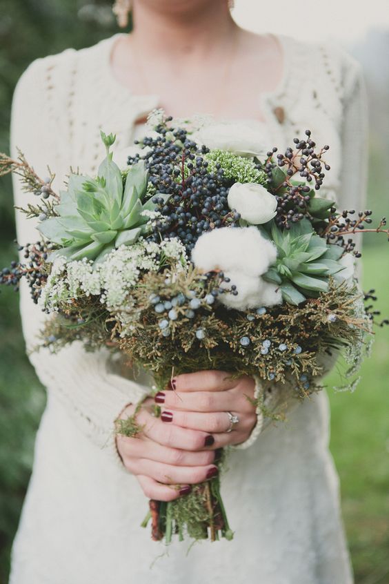 a beautiful textural winter wedding bouquet with cotton, succulents, privet berries and textural foliage is a very creative idea