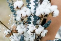 a beautiful wedding bouquet of silver dollar eucalyptus, cotton branches and silver berries is a gorgeous idea for a summer boho bride