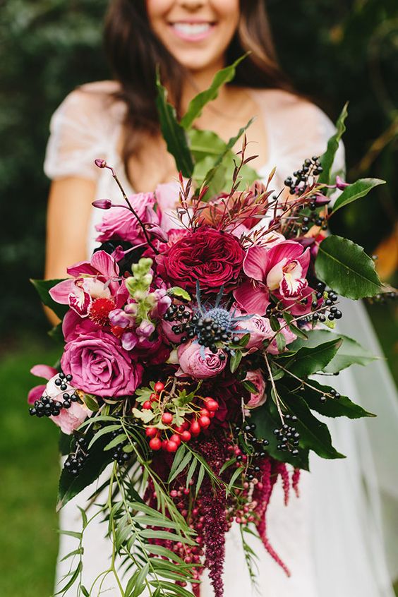 a colorful fall wedding bouquet of pink, fuchsia, burgundy blooms, several types of berries and lots of foliage is a lovely idea for the fall