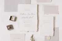 a delicate and ethereal light grey and white wedding invitation suite with a raw edge and calligraphy is a fantastic idea for a minimalist wedding