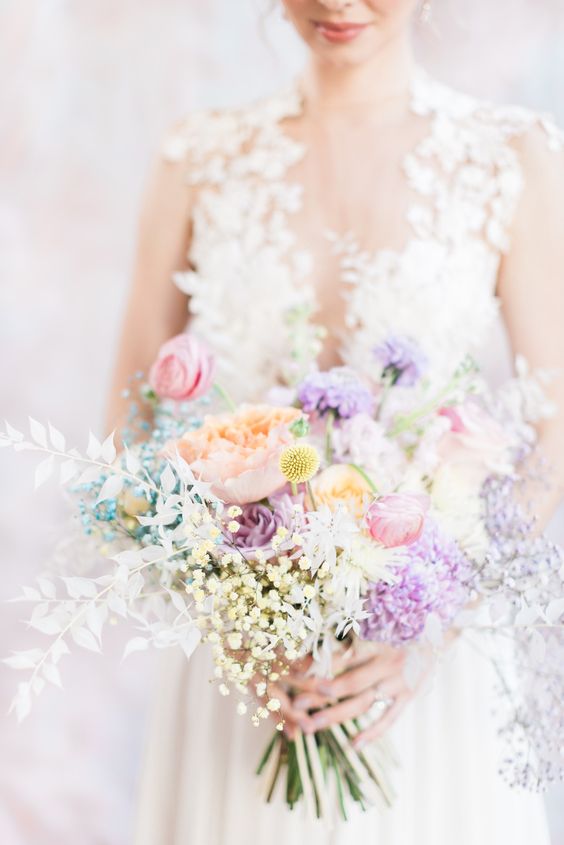a delicate iridescent wedding bouquet with purple, lilac, pink, blush and white blooms and billy balls is a stylish idea