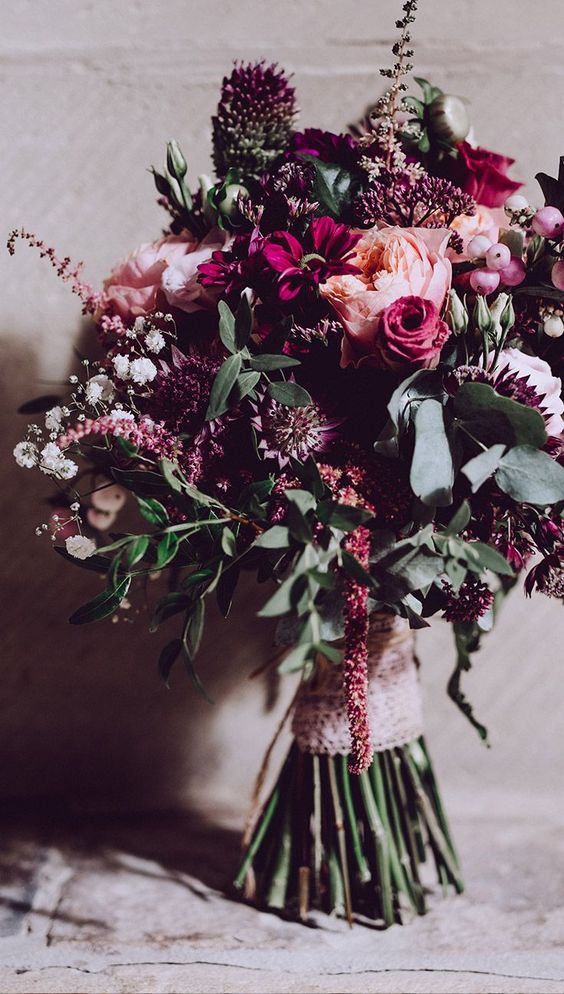 a gorgeous bold wedding bouquet with pink, blush, deep purple and white blooms of various kinds, greenery and some pink berries is cool for a fall bride