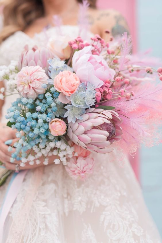 a gorgeous iridescent wedding bouquet with blue and pink blowers and dried and spray painted ones is a beautiful idea to rock