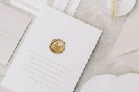 a gorgeous neutral minimalist wedding invitation suite with tan touches, neutral lettering, a gold stamp and curved menus