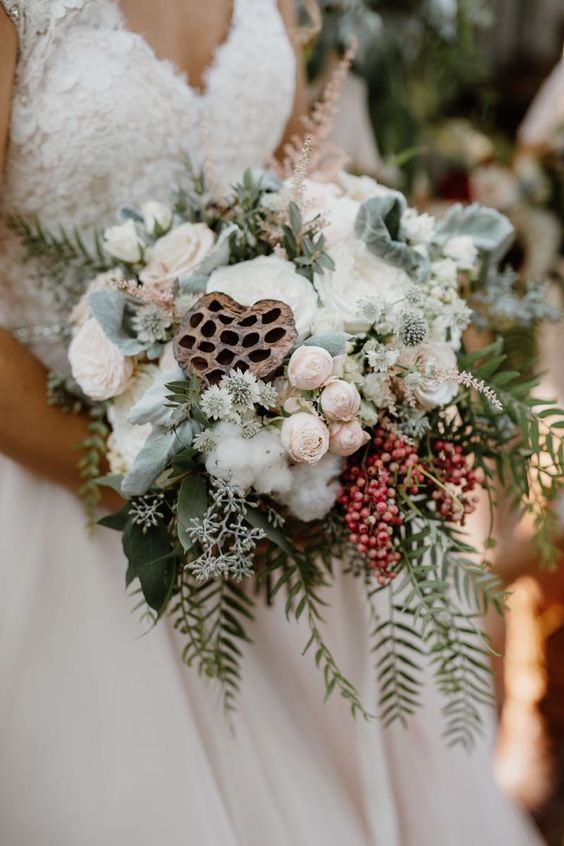 a lovely cascading wedding bouquet of blush and white blooms, cotton, lotus, berries and greenery is a lovely idea for a summer bride