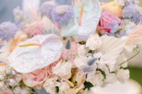 a lovely iridescent wedding bouquet with fresh and dried blooms, leaves and grasses spray painted pink, lilac and iridescent is wow