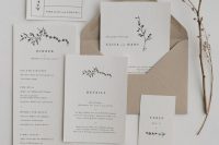 a minimalist wedding invitation suite in neutrals and with a kraft paper envelope, with black lettering and a bit of botanical prints