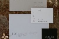 a minimalist wedding invitation suite in white, light grey and black, with modern lettering and a bit of calligraphy shows off the color schene