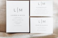 a modern to minimalist wedding invitation suite in white, with black lettering and nothing else – who needs more than that