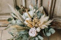 a neutral boho wedding bouquet of white and light pink blooms, pampas grass, greenery and foliage is a lovely idea for a boho bride