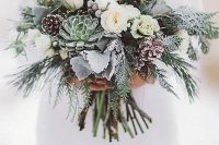 a snowy winter wedding bouquet of white blooms, succulents, pale leaves, evergreens, berries and pinecones is a gorgeous idea