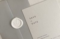 a stylish light grey and grey save the date suite with simple black lettering and a white stamp is a cool and chic minimalist idea