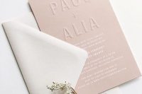 an airy minimalist wedding invitation suite with a dusty pink envelope and letter pressing, white printing and a neutral envelope