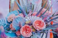 an amazing iridescent wedding bouquet with pink, blue, lilac blooms, grasses and fronds and with iridescent elements is wow