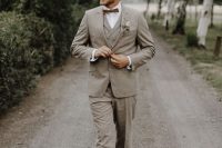 an elegant greige three-piece suit with a brown bow tie and brown shoes is a chic idea for spring, summer or fall