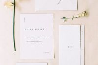 an elegant white minimalist wedding invitation suite with a raw edge and black lettering is a perfect idea for a minimal wedding