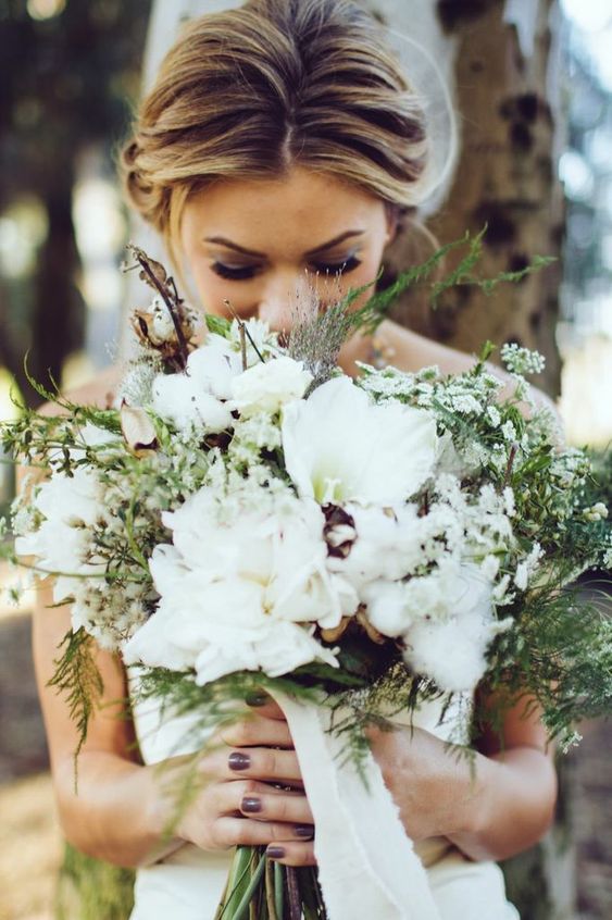 an extremely textural cotton wedding bouquet with white blooms, smaller wildflowers, greenery and twigs is a lovely idea for a woodland bride