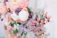 an iridescent wedding bouquet of lilac, blush, coral and white blooms is a gorgeous solution to rock