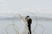 an ultra-minimalist wedding altar of gilded circles on stands, with a fantastic view of Salt Flats is wow