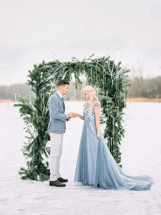 a gorgeous evergreen winter wedding arch