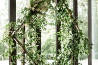 a creative lush greenery wedding arch with a geometric shape is a lovely solution for a modern or minimalist wedding