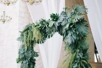 a stylish tropical wedding arch design