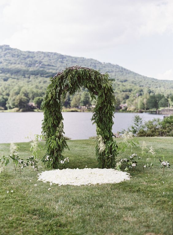 a lush evergreen wedding arch is a cool solution for an outdoor woodland or just winter wedding