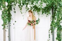 a super lush greenery wedding arbor with cascading leaves and vines is a beautiful solution for a spring or summer wedding
