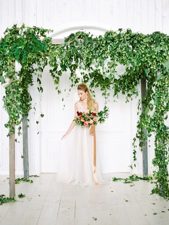 a super lush greenery wedding arbor with cascading leaves and vines is a beautiful solution for a spring or summer wedding