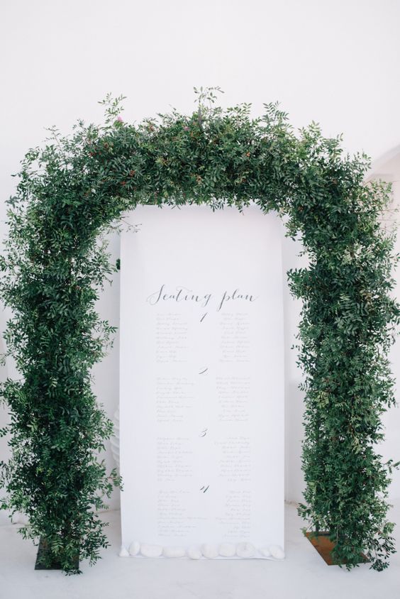 a super lush greenery wedding arch is a beautiful idea for a modern wedding, it looks unusual and very cool and bold