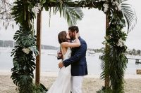 a tropical wedding arbor with lush tropical foliage and some white orchids is a perfect solution for a modern tropical wedding