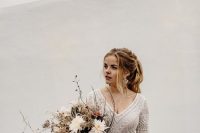 05 a chic modern winter bridal look with a boho lace top and a pleated maxi skirt plus a metallic belt and a lovely textural wedding bouquet