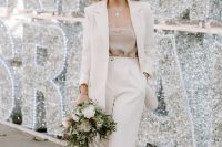 09 a modern winter bridal outfit with a neutral pantsuit, a tan lace top, blue shoes and a headband is a lovely idea for a micro wedding