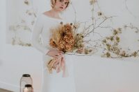 10 a modern winter bridal outfit with a white plain A-line wedding dress with a bateau neckline and long sleeves, a train and a headpiece with a veil