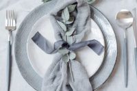 17 a chic grey winter wedding tablescape with a grey table runner, grey plates, eucalyptus and grey cutlery