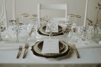 19 a dreamy and airy modern winter wedding tablescape with neutral linens, dried branches and blooms, black and white plates and dark cutlery