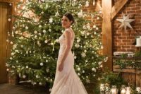 20 a Christmas tree decorated with white ornaments and lights is a gorgeous wedding backdrop for a Christmas wedding